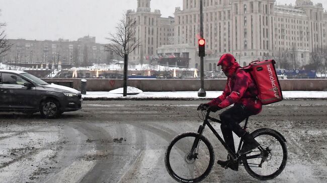 Курьер службы доставки Самокат везет заказ по Москве