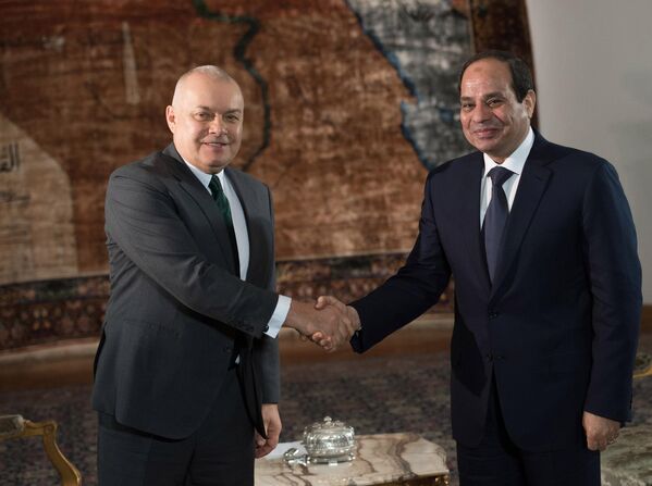 Президент Египта Абдель Фаттах Ас-Cиси и генеральный директор медиагруппы Россия сегодня Дмитрий Киселев приветствуют друг друга во время встречи в Каире