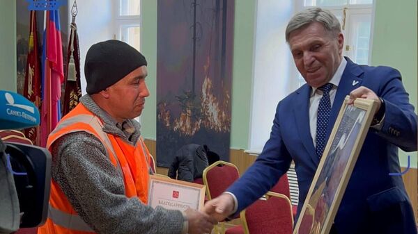 Вручение картины дворнику, который помог спасти людей при пожаре в квартире в Санкт-Петербурге