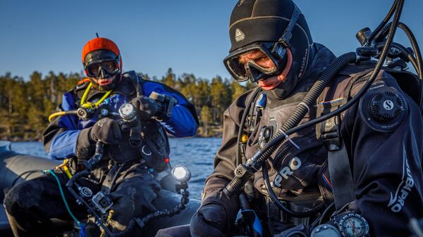 Дайвер 1XPEDITION Александр Архипов и Олег Шабуня готовятся к визуальному обследованию затонувших объектов на дне Ладожского озера