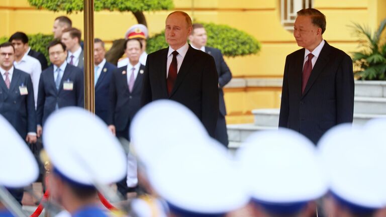 Президент России Владимир Путин и президент Социалистической Республики  Вьетнам То Лам на церемонии официальной встречи на площади у Президентского дворца в Ханое