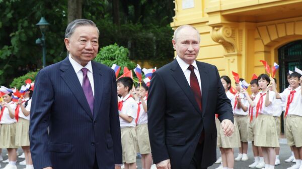 Президент РФ Владимир Путин и президент Социалистической Республики Вьетнам То Лам на церемонии официальной встречи на площади у Президентского дворца в Ханое