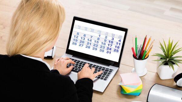 Предпринимательница смотрит календарь на ноутбуке