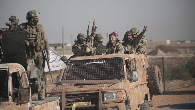 Члены Сирийской национальной армии на дороге в Манбидж, Сирия