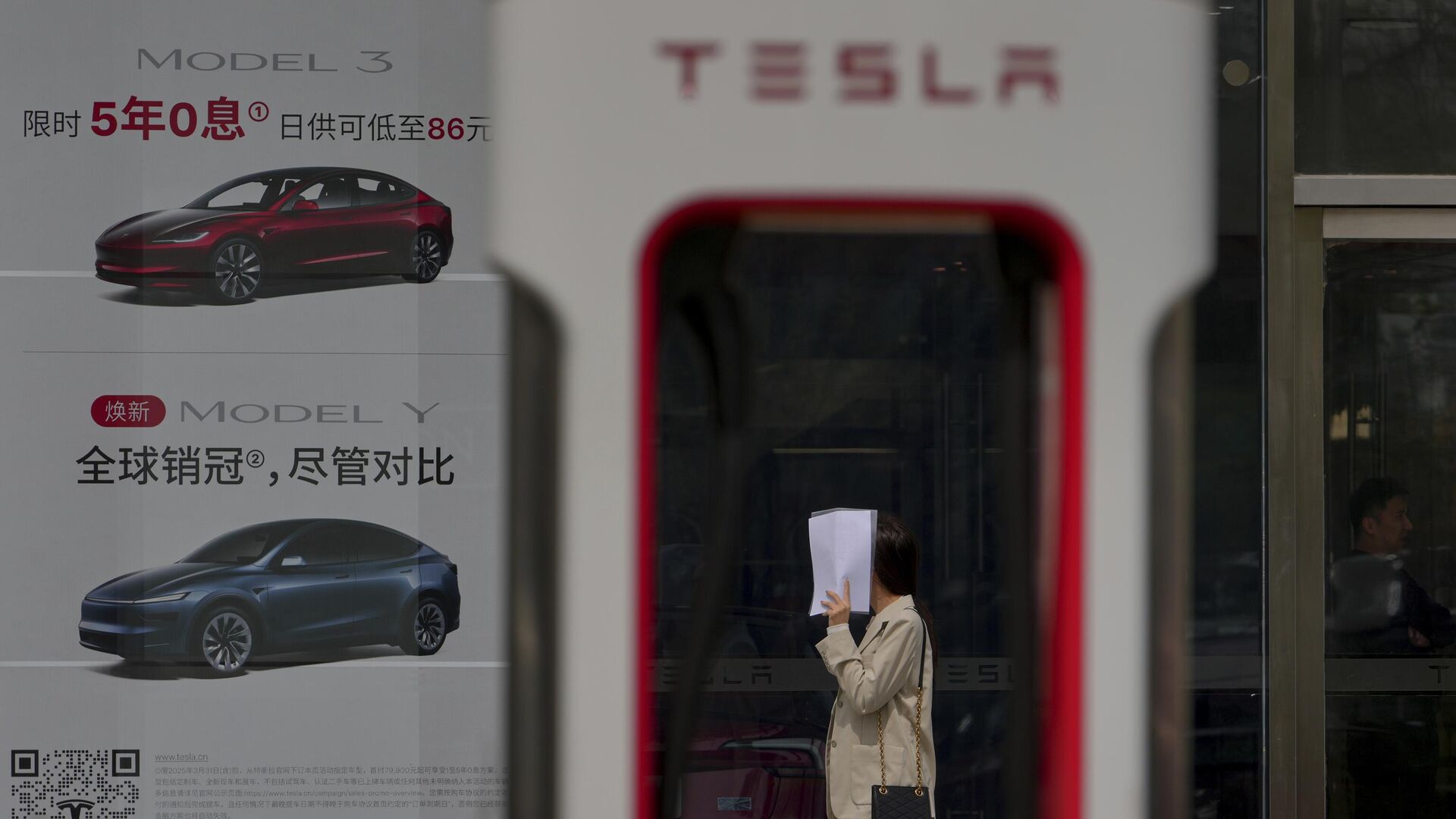 Станция зарядки электромобилей возле дилерского центра Tesla в Пекине, Китай - РИА Новости, 1920, 15.11.2025