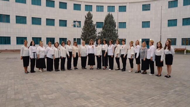 Ученики и преподаватели туркмено-российской школы имени А.С. Пушкина в Ашхабаде исполненяют песни военных лет. Кадр видео