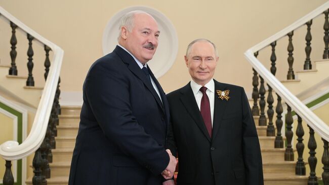 Президент России Владимир Путин приветствует президента Белоруссии Александра Лукашенко в Москве