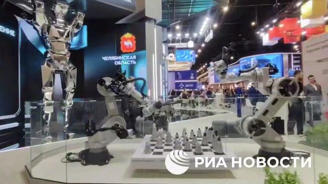 Роботизированные манипуляторы играют в шахматы на стенде Челябинской области на ПМЭФ-2025. Кадр видео