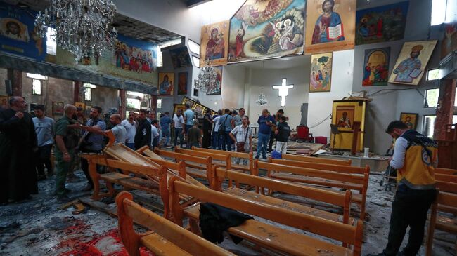 На месте взрыва в церкви в районе Дувейла в Дамаске, Сирия