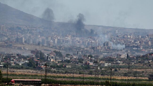 Дым в городе Сувейда на юге Сирии