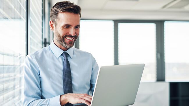 Предприниматель работает за ноутбуком в офисе