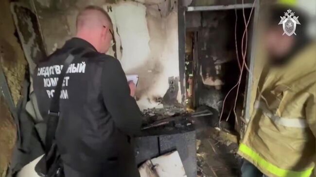 Сотрудники Следственного комитета на месте убийства архитектора Александр Супоницкого. Кадр видео