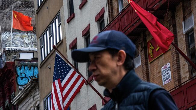 Государственные флаги США и Китая в районе Чайнатаун ​​в Нью-Йорке