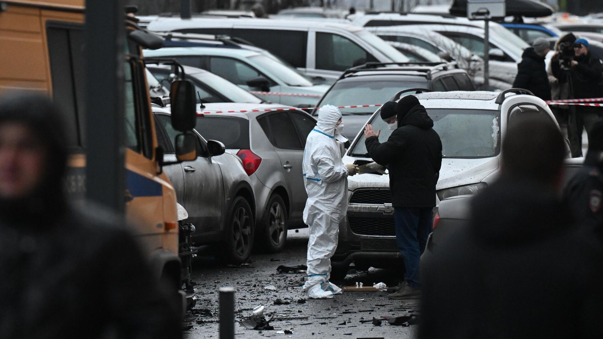 Сотрудники спецслужб работают на месте взрыва автомобиля Kia Sorento на парковке на улице Ясеневая в районе Орехово-Борисово - РИА Новости, 1920, 22.12.2025