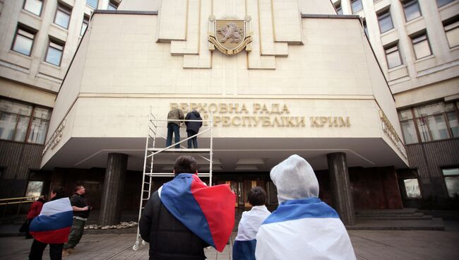 Рабочие снимают вывеску Верховной Рады Автономной республики Крым на украинском языке. Архивное фото