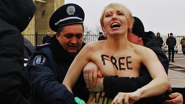 Cотрудники правоохранительных органов Украины задерживают активистку движения Femen. Архивное фото