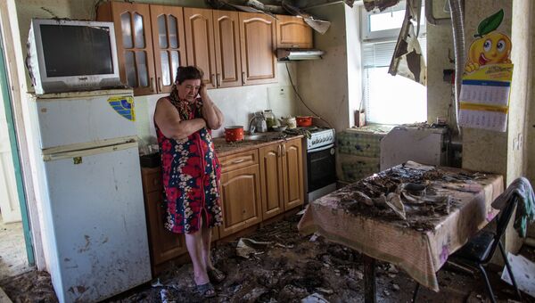 Женщина в своем доме, разрушенном в результате ночного артобстрела со стороны украинских военных на окраине Славянска. Архивное фото