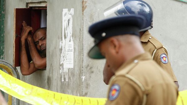 Мусульманский мужчина выглядывает из окна во время полицейского рейда в Шри-Ланке. Архивное фото