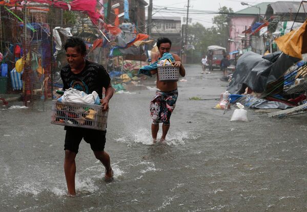 Жители города Имус, Филиппины, спасаются от тайфуна Раммасун