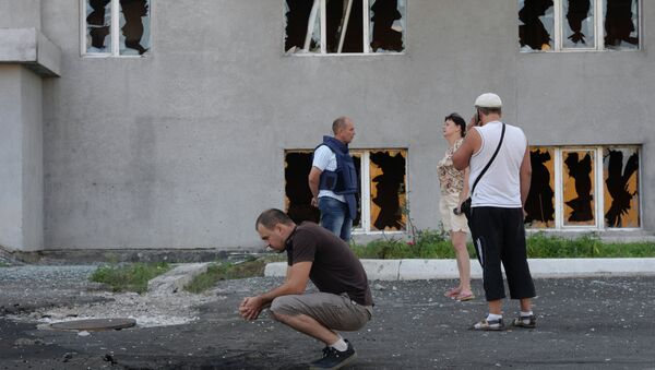 Жильцы многоэтажного дома, пострадавшего после артиллерийского обстрела города Донецка украинской армией