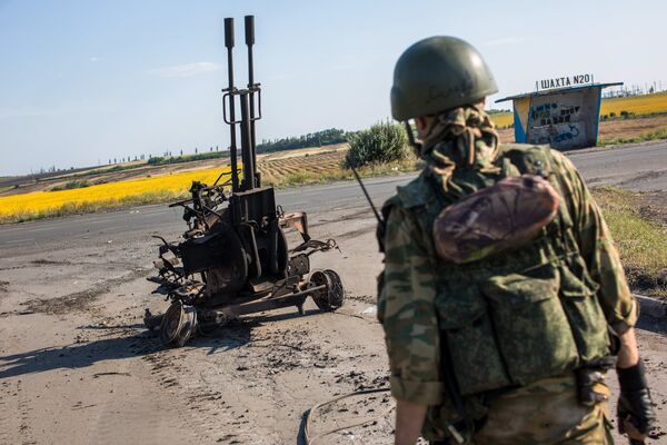 Боец народного ополчения возле сгоревшей зенитной установки ЗУ-232 украинской армии