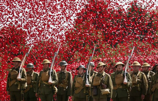 Члены исторического общества, одетые в форму солдат Первой Мировой, под дождем из цветков мака