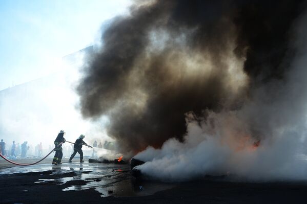 Пожарные тушат подожженные активистами покрышки на площади Независимости в Киеве