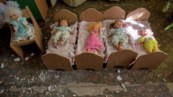 Брошенные игрушки в разрушенном в результате артиллерийского обстрела украинскими военными детском саду. Архивное фото