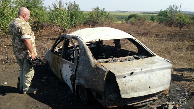 Сгоревший автомобиль на месте гибели фотокорреспондента МИА Россия сегодня Андрея Стенина