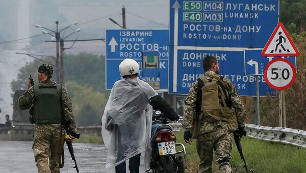 Украинские военнослужащие ведут задержанного возле КПП в Дебальцево