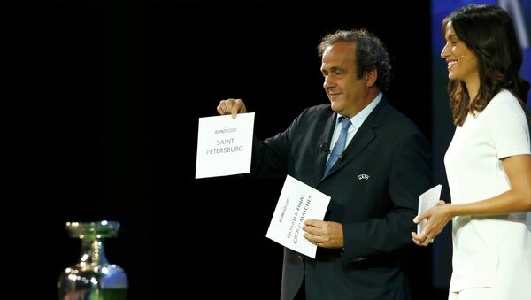 Президент УЕФА Платини показывает табличку города Санкт-Петербург