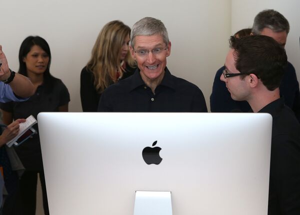 Генеральный директор Apple Тим Кук смотрит на новый iMac