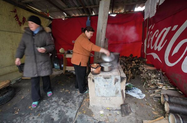 Женщины готовят еду на походной кухне, после обстрела села Спартак и Донецка