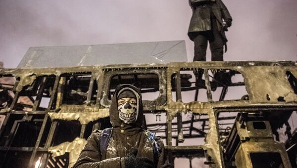 Сторонники евроинтеграции Украины на крыше выгоревшей техники на улице Грушевского в Киеве