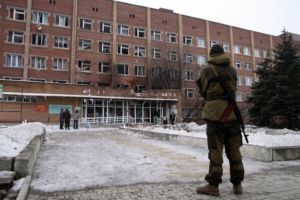 Вооруженный ополченец возле больницы, пострадавшей от обстрела ВСУ