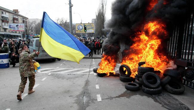 Военнослужащие из батальона Айдар снимают украинский флаг со здания Министерства обороны Украины