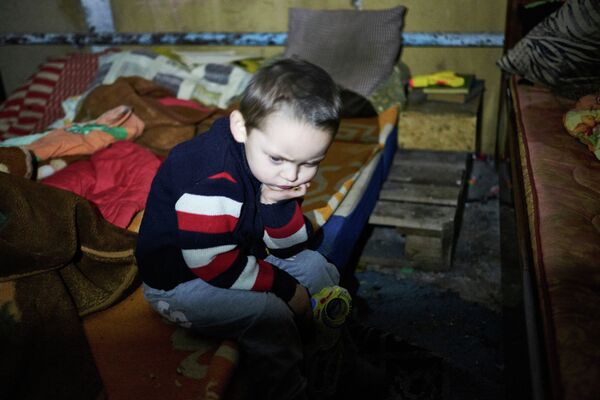 Мальчик укрывается от обстрела Донецка в бомбоубежище