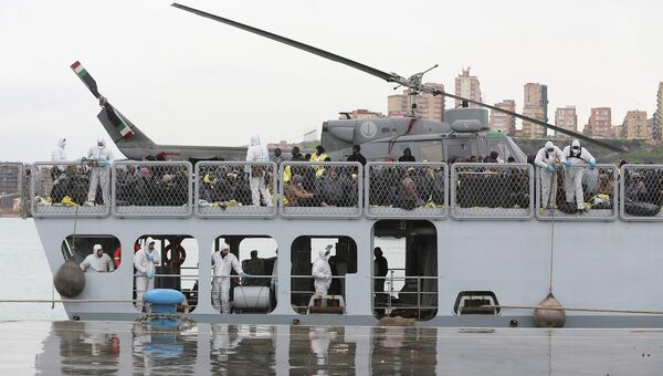 Мигранты из Ливии на итальянском военном корабле в порту Сицилии. 17 февраля 2015