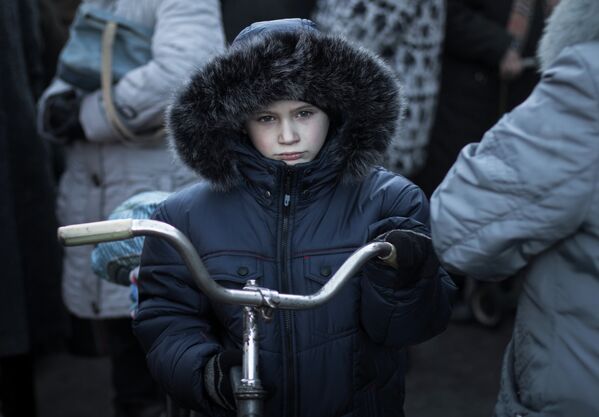 Ребенок во время получения гуманитарной помощи от ополченцев ДНР