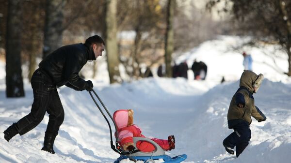 Отец с детьми гуляет в московском парке. Архивное фото