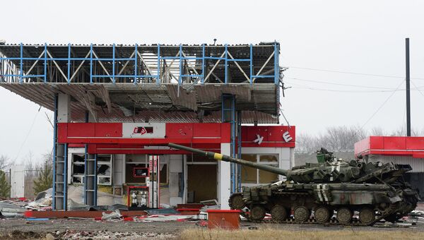 Поврежденный танк украинской армии возле разрушенной заправки в Дебальцево, Украина