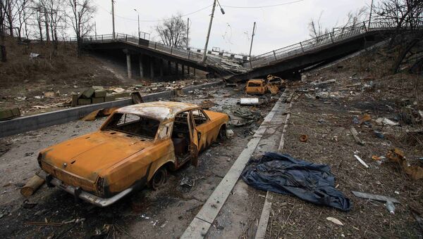 Сгоревшие автомобили под разрушенным мостом в районе аэропорта Донецка, Украина
