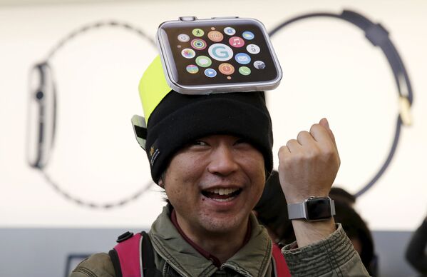 Счастливый покупатель примеряет часы Apple во время демонстрации в одном из Apple Store, Токио. Апрель 2015