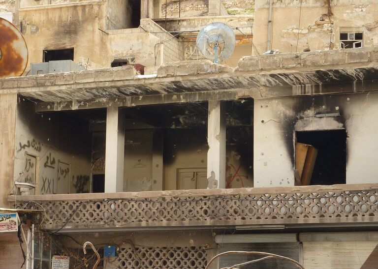 Пострадавшее от боевых действие здание в сирийском городе Маалюля в 55 км от Дамаска Пострадавшее от боевых действие здание в сирийском городе Маалюля в 55 км от Дамаска