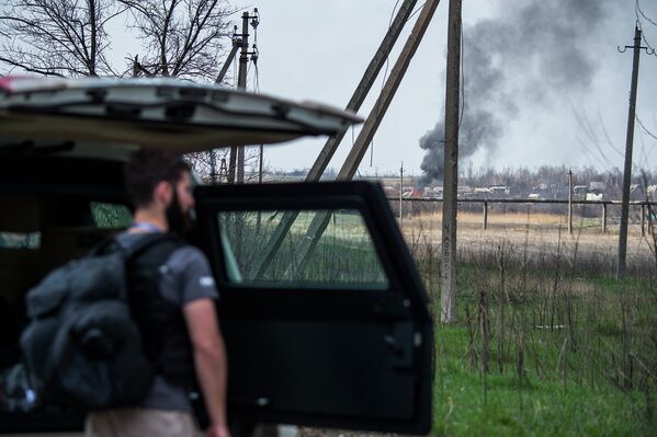 Наблюдатель ОБСЕ у бронированного автомобиля недалеко от аэропорта в Донецке. Апрель 2015