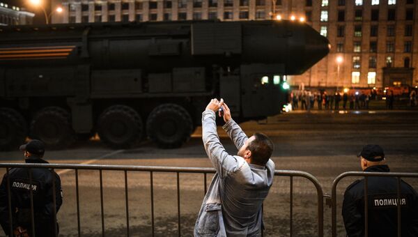 Колонна военной техники проходит у станции метро Маяковская во время репетиции парада Победы