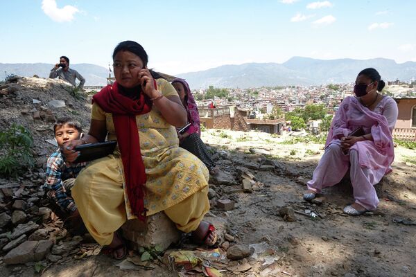 Местные жители на одной из улиц Катманду, разрушенной в результате землетрясения