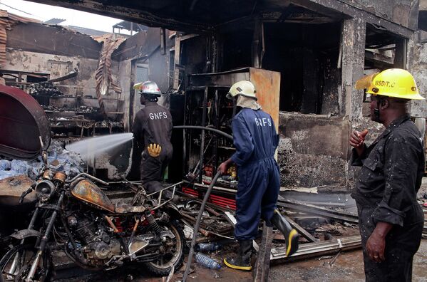 Пожарные на автозаправочной станции в городе Аккра в Гане после взрыва