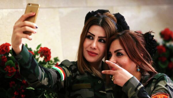 Девушки из рядов курдских военизированных формирований делают селфи