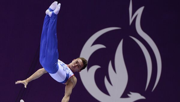 Давид Белявский (Россия) выполняет упражнение на брусьях во время командных соревнований по спортивной гимнастике среди мужчин на I Европейских играх в Баку